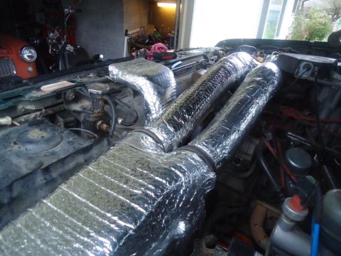 1995 Ford Bronco - Insulated dual air intake tubes are visible in the engine bay of this vehicle.