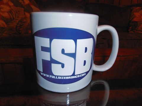 1990 Ford Bronco - A white mug with the FSB logo and website address is displayed on a reflective surface.