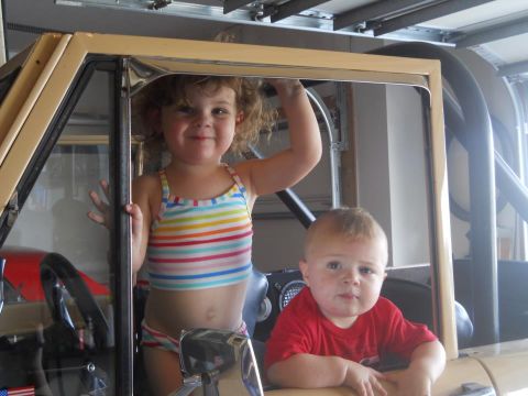1976 Ford Bronco - Two young children are pictured inside the cabin of a vehicle.