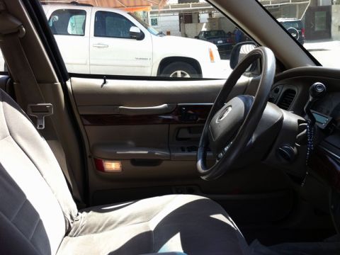 2001 Mercury Grand Marquis - The interior of a 2001 Mercury Grand Marquis is visible, with a white SUV parked outside.