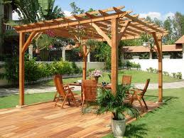 1984 Ford Bronco - Outdoor living space with a wooden pergola, deck, and garden furniture.