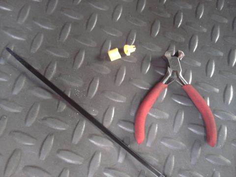 1996 Ford Bronco - Tools and parts laid out on a textured surface, possibly for a vehicle repair.