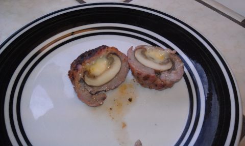 1989 Ford Bronco - A close-up view of a meat and mushroom dish, cut in half, on a plate.