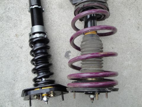 1995 Ford Taurus - Two aftermarket coilover suspension assemblies are shown side-by-side for comparison.