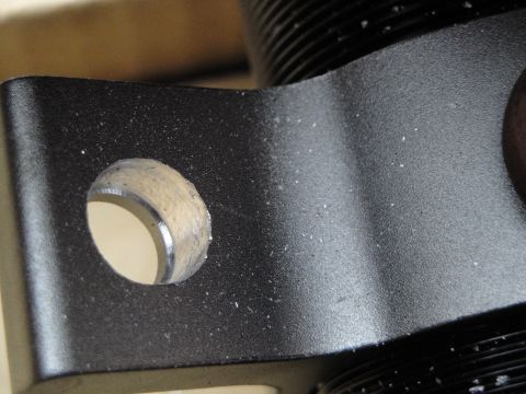 1995 Ford Taurus - Detail of a black metal bracket, likely a component of a coilover suspension system.