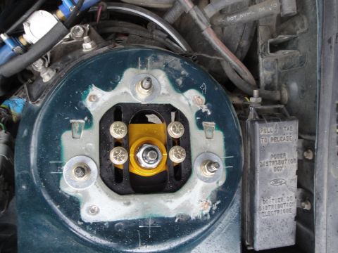 1995 Ford Taurus - Close-up of an adjustable coilover suspension component and power distribution box.