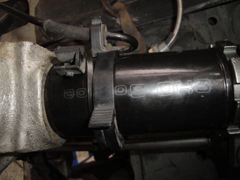 1995 Ford Taurus - A black coilover shock absorber is shown, with "SHO" and "CE" embossed on its side.