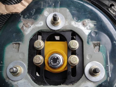 1995 Ford Taurus - Close-up of an adjustable coilover mount, a yellow knob for damping adjustment.