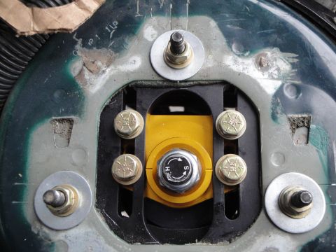 1995 Ford Taurus - Adjustable suspension strut mount with hardware and directional markings.