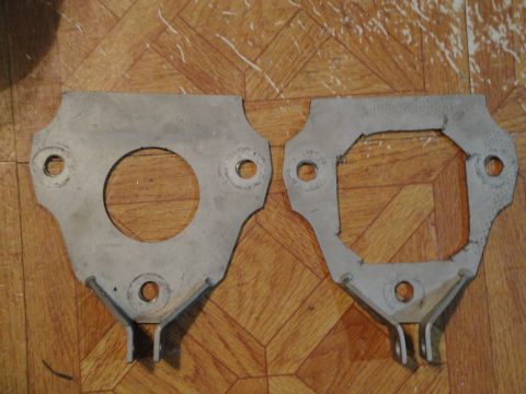 1995 Ford Taurus - Two metal brackets are shown against a wood-paneled background.