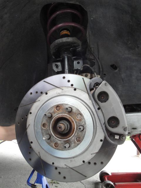 1995 Ford Taurus - This photo shows a car's brake system, including the rotor, caliper, and suspension components.