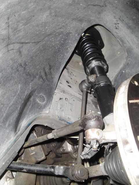 1995 Ford Taurus - Close-up view of a vehicle's front suspension system, highlighting the coilover and steering components.