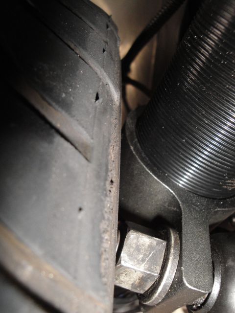 1995 Ford Taurus - A detailed view of a tire and a suspension component, likely from a vehicle's wheel well.