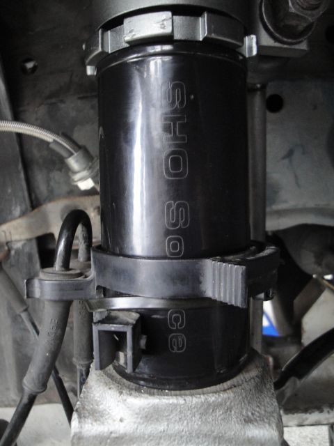 1995 Ford Taurus - A close-up view of a vehicle's suspension component, possibly a coilover shock.