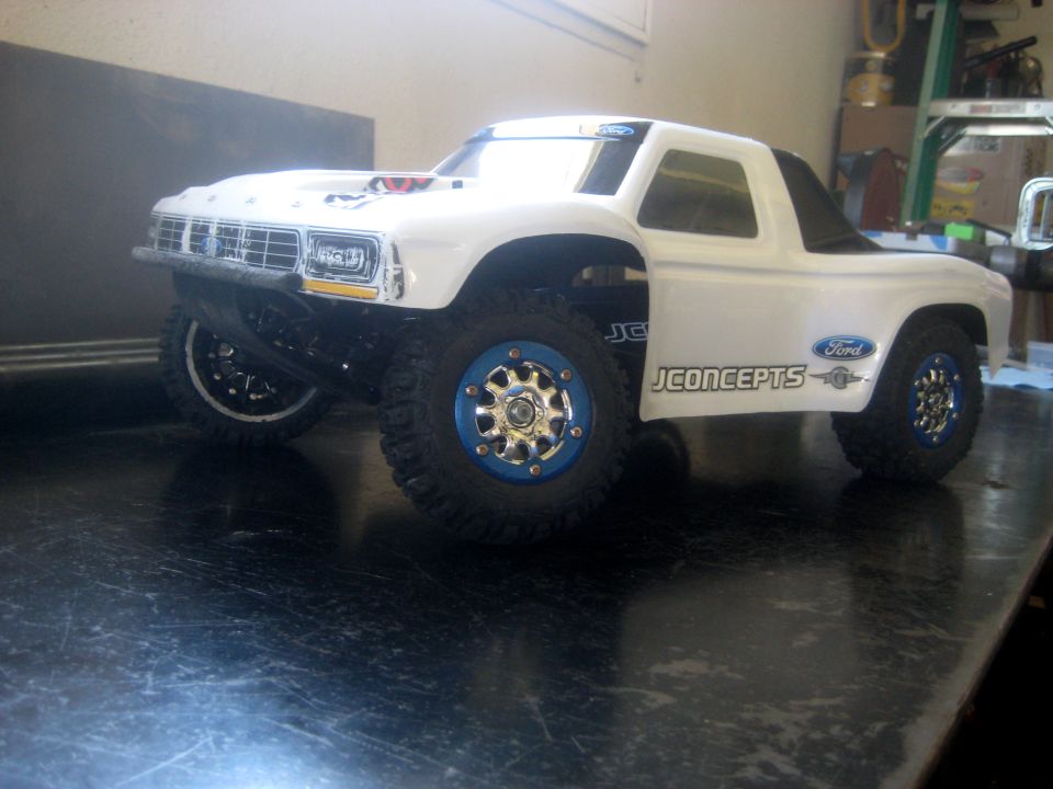 White RC car body with blue-accented wheels, labeled JCONCEPTS and Ford