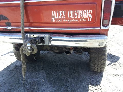 1978 Ford Bronco - Rear view of a 1978 Ford Bronco, a custom decal and tow hitch, suggesting it's ready for off-road adventures.