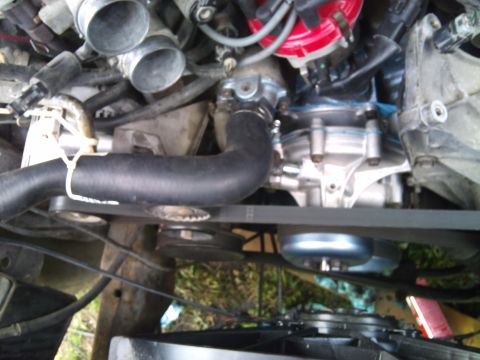 1994 Ford Bronco - Close-up view of an engine bay, showing various mechanical parts and hoses.