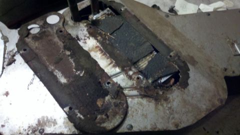1978 Ford Bronco - This is a close-up of a heavily rusted metal part, likely from a vehicle's undercarriage.
