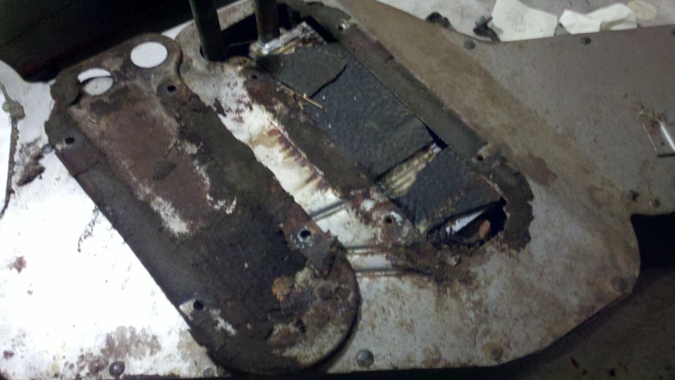 rusted metal undercarriage part with some black padding