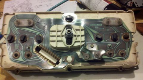 1978 Ford Bronco - The back of a vehicle's instrument cluster shows its complex circuitry and connection points.