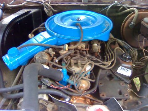 1979 Ford Bronco - Close-up view of a vehicle's engine bay, showing the air filter housing and engine components.