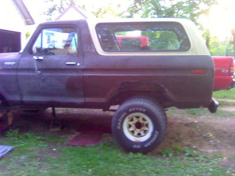 1979 Ford Bronco - This 1979 Ford Bronco is seen from the side, showing its two-tone paint scheme and classic SUV body style.
