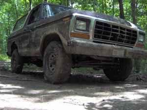 1979 Ford Bronco - Ford Bronco off-road in a wooded area.