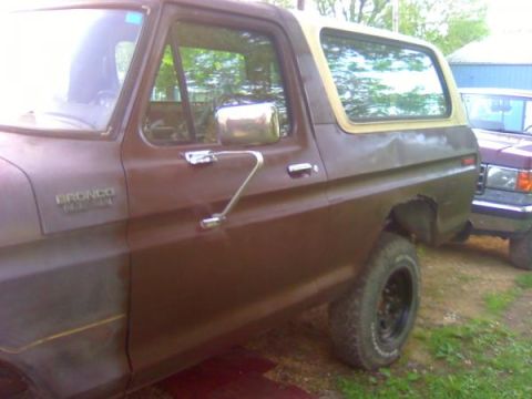 1979 Ford Bronco - Side profile of a 1979 Ford Bronco, showing its distinctive body style and two-tone paint.
