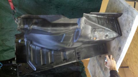 1978 Ford Bronco - A metal undercarriage component is shown, likely undergoing restoration or repair.