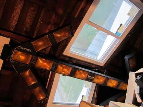 1991 Ford LTD Crown Victoria - An arrow-shaped light fixture with multiple amber lenses is mounted indoors near a skylight.