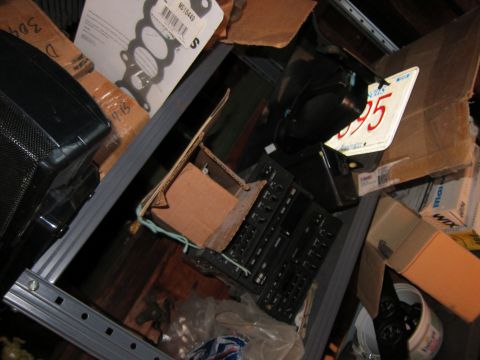 1991 Ford LTD Crown Victoria - A cluttered car interior scene shows various automotive parts and a license plate, with no clear vehicle identification.