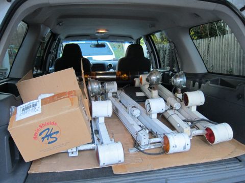 1991 Ford LTD Crown Victoria - The interior of an SUV is filled with equipment, including several light bars and cardboard boxes.