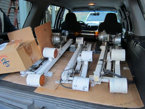 1991 Ford LTD Crown Victoria - Boxes and industrial equipment are loaded into the cargo area of a vehicle.