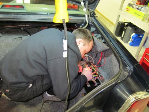 1991 Ford LTD Crown Victoria - Working on the electrical system in the trunk of a car.