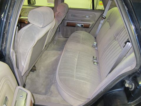 1991 Ford LTD Crown Victoria - Rear interior view of a 1991 Ford Crown Victoria LTD, showing the cloth seats and door panel.