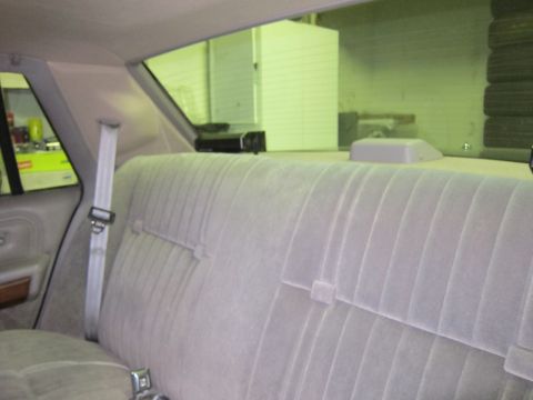 1991 Ford LTD Crown Victoria - The interior of a car is shown, focusing on the rear seat and the view through the rear window.