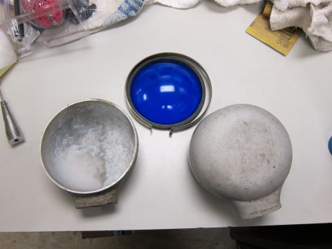 1991 Ford LTD Crown Victoria - Disassembled blue sphere and metal housing components on a workbench.