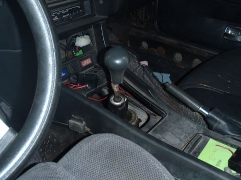 1978 Nissan 300ZX - Interior view of a car's center console, highlighting the manual transmission shifter and handbrake lever.