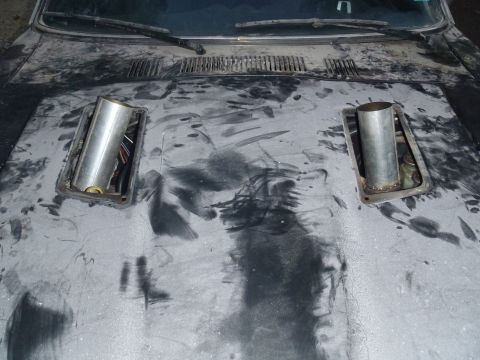 1978 Nissan 300ZX - Custom exhaust pipes installed on a car's hood, showing unfinished modifications.