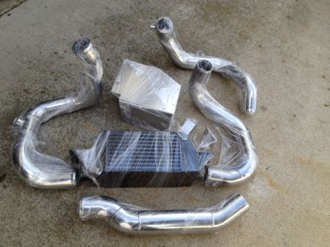 2004 Ford Crown Victoria - This photo shows a collection of polished aluminum piping and an intercooler, likely for a vehicle's performance upgrade.
