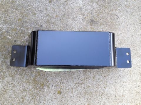 2004 Ford Crown Victoria - A black supercharger with two mounting brackets is shown resting on a concrete surface.