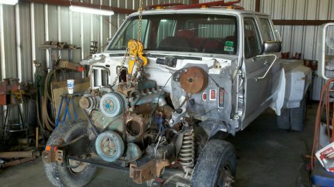 1993 Ford F-350 - This Ford F-350 is undergoing engine work in a garage, with the engine hoisted out of the engine bay.