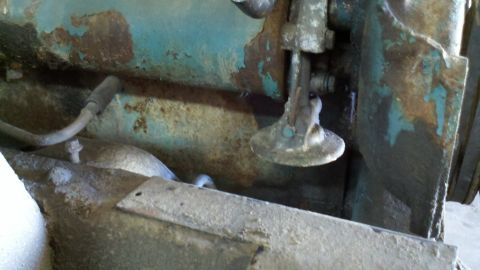 1993 Ford F-350 - Close-up view of corroded engine components, showing a valve mechanism and metal tubing.
