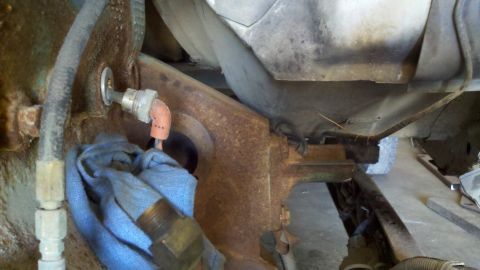 1993 Ford F-350 - Detail of a mechanical part within the engine bay, partially obscured by a blue cloth.