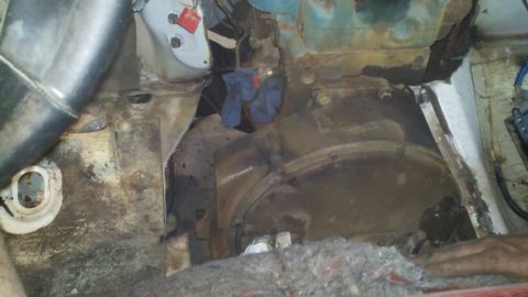 1993 Ford F-350 - The engine bay shows significant rust and dirt, with a large transmission housing and a blue cloth visible.