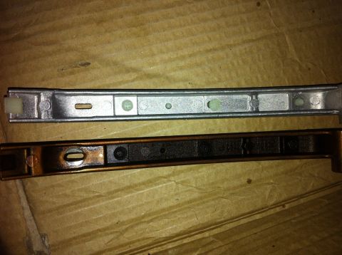 1998 Ford Crown Victoria - Comparison of a new timing chain guide next to a used and worn one.