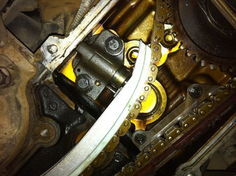 1998 Ford Crown Victoria - Engine internal components, including timing chains and tensioner, are visible in this close-up shot.