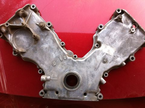 1998 Ford Crown Victoria - This timing cover shows several stamped part numbers, indicating its specific application.