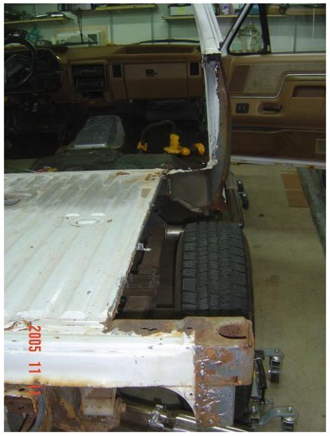 1988 Ford Bronco - Interior view of a truck, showing dashboard and passenger area, with rear quarter panel and tire visible.