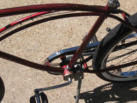 1994 Ford Bronco - A close-up view of a bicycle's frame, chain, and rear wheel, resting on a concrete surface.
